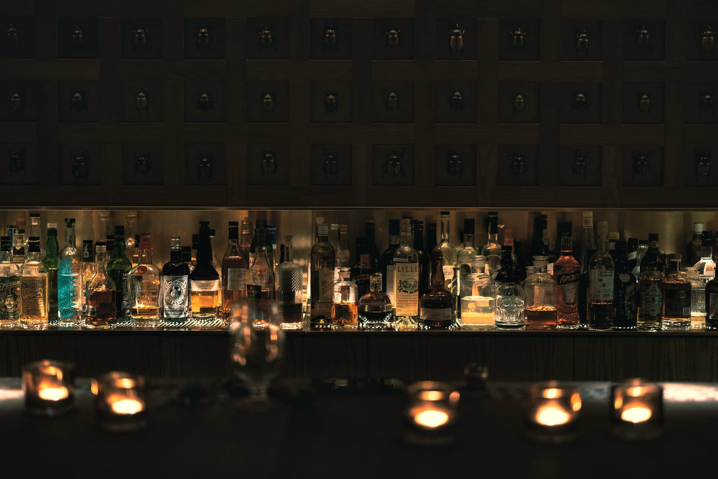 Candlelit bottles and tealights along the bar at Opium